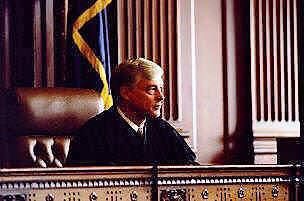 Judge sitting on a courtroom bench